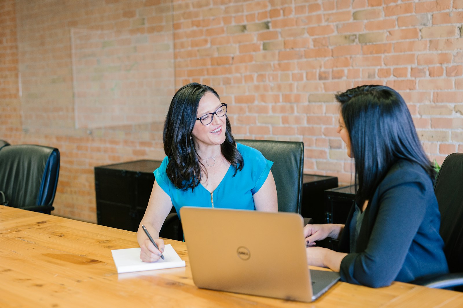 A marketer drafting templates at a desk full of notes